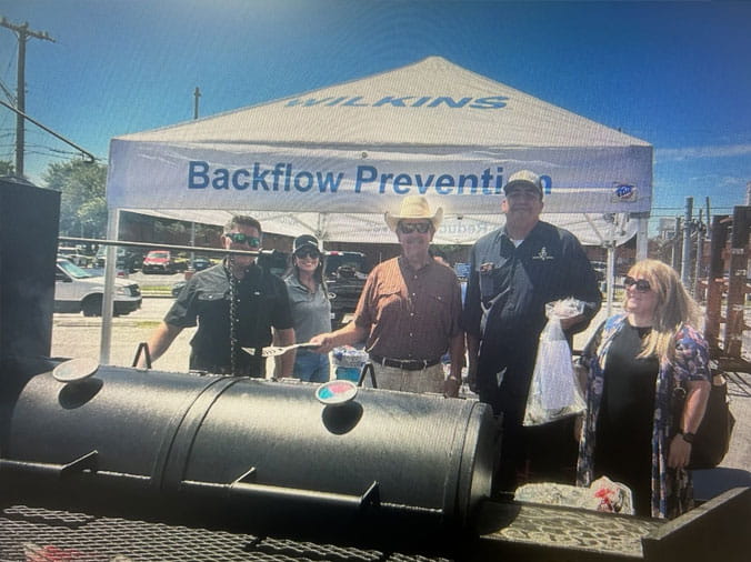 Wilkins Backflow Prevention tent behins a BBQ